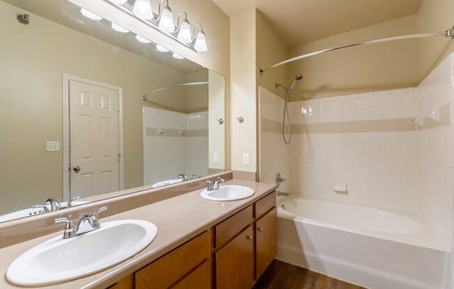 a bathroom with two sinks and a bathtub