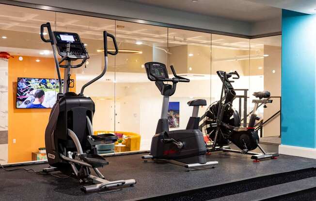 a gym with exercise equipment in the lobby of a building