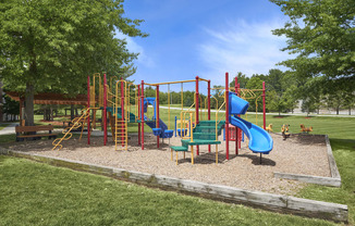 a playground with slides and other toys in a park