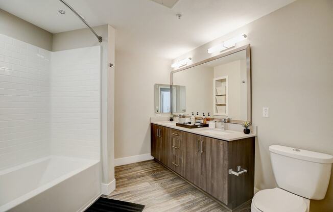 a bathroom with a large mirror and a toilet