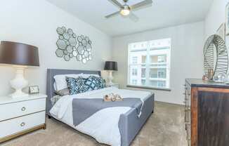 a bedroom with a bed and a ceiling fan