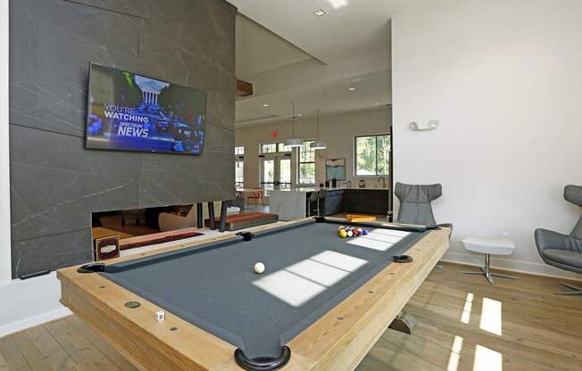 Gaming lounge with fireplace and TV