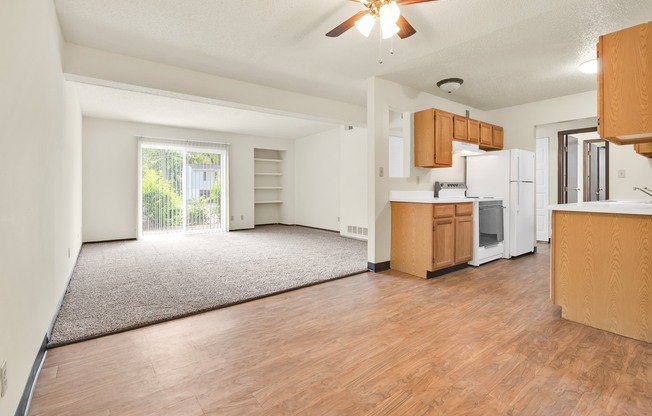 A room with wooden floors and a ceiling fan.