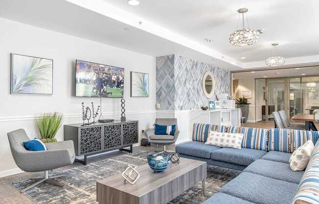 Parkside Commons community room with a grey armchair, a wooden coffee table, and a blue sofa.