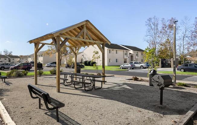 a picnic area with benches and a grill