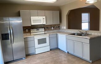 REMODELED HOUSE NEW CABINETS  NEXT TO CAVZOS  HOOD WITH STAINLESS FRIDGE