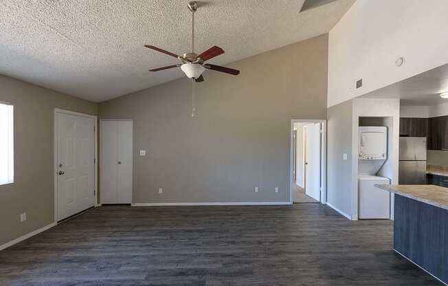 a empty living room with a ceiling fan