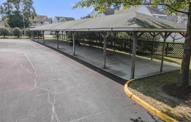 a park with a gazebo on the side of a street