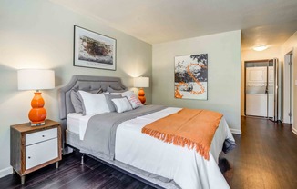 One Bedroom Apartments in Walnut Creek, CA - Park Lake at Walnut Creek - Furnished Bedroom with Distinctive Wood-Style Flooring, Stylish Decor, and an In-Unit Washer and Dryer