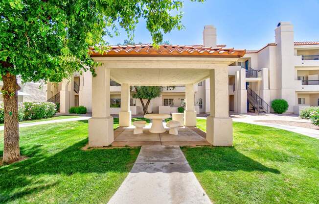 A white building with a red tile roof and a white pillar.