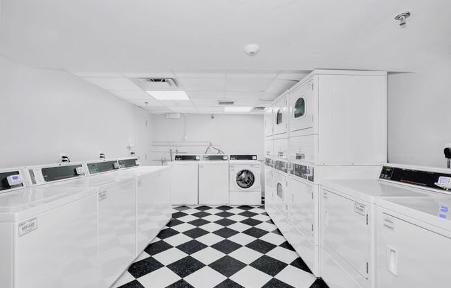 the kitchen has a checkered floor and white appliances