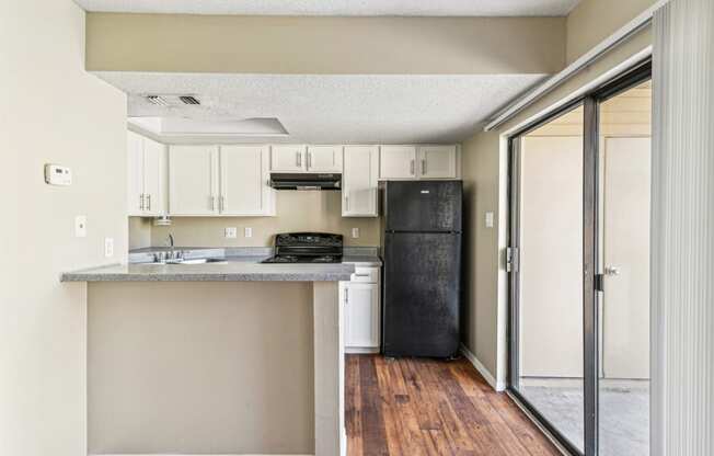 Gourmet kitchen with black appliances at Bandera Crossing apartments in San Antonio, TX