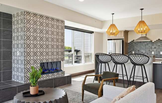 a living room with a fireplace and a kitchen in the background
