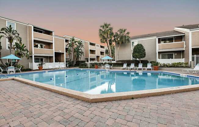 a large swimming pool in front of an apartment building