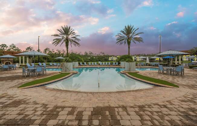 a pool with chairs and umbrellas at a resort