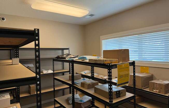 A storage room with shelves filled with boxes and a sign that reads "20-212".