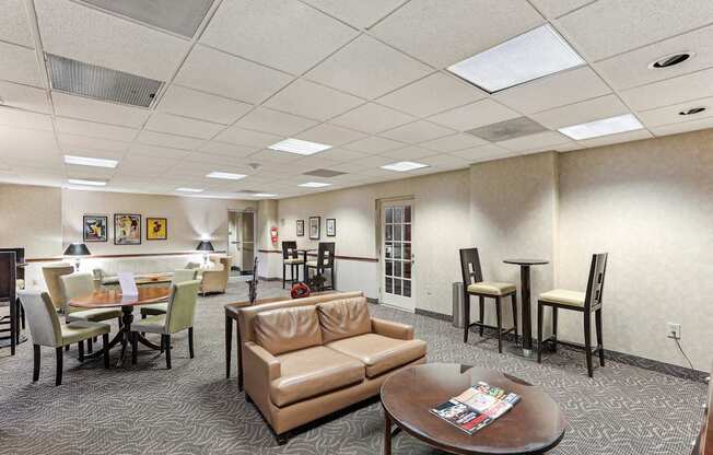 A conference room with a table, chairs, and a couch.