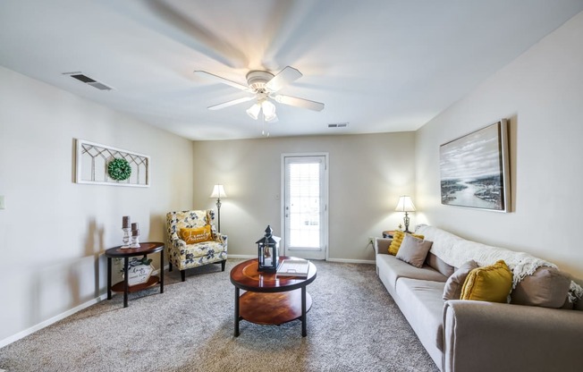 a living room with a ceiling fan and a couch