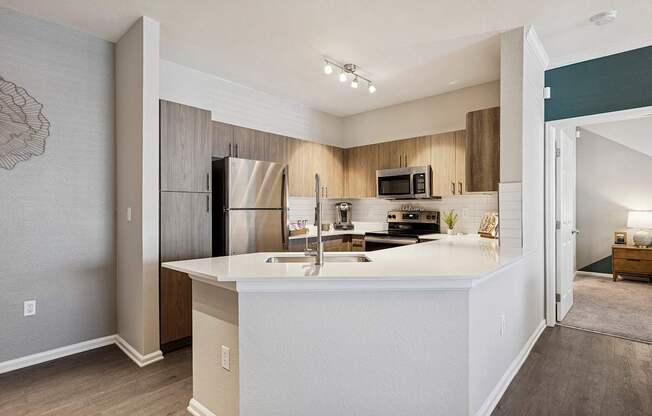 A kitchen with a white countertop and a refrigerator.