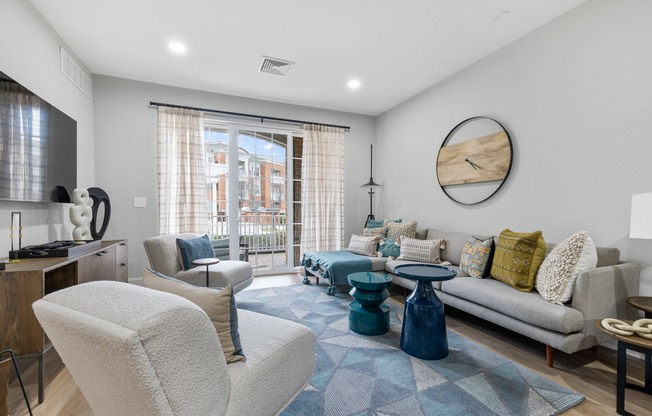 a living room with couches and chairs and a sliding glass door