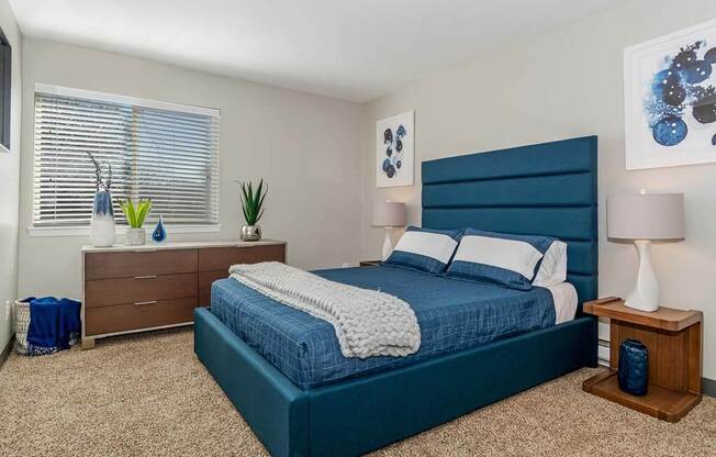 a bedroom with a bed and a dresser at Renew Madison, Madison