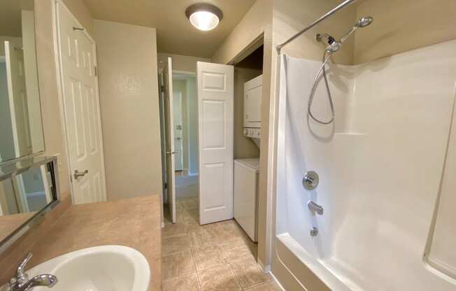 a bathroom with a shower and a sink