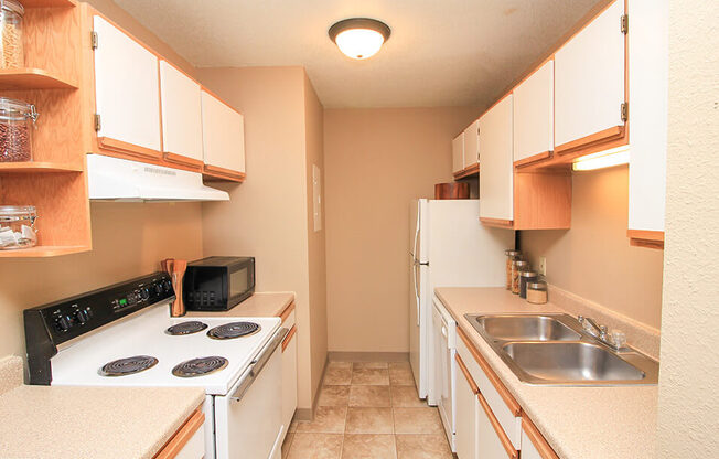 a kitchen with a stove top oven next to a sink