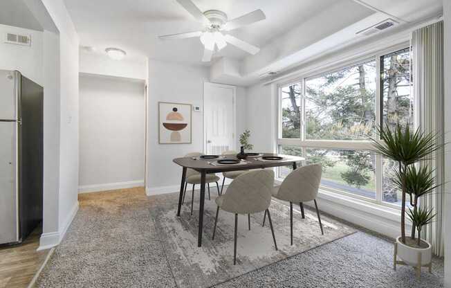 A dining room with a table and chairs.