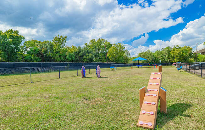A playground with a slide and two people in the distance.