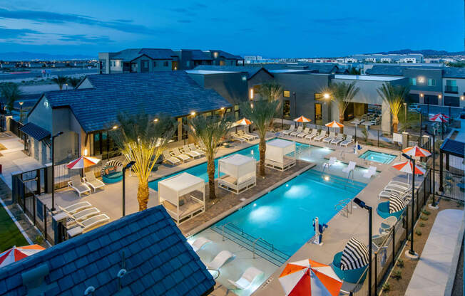 a view of the pool at the resort at night