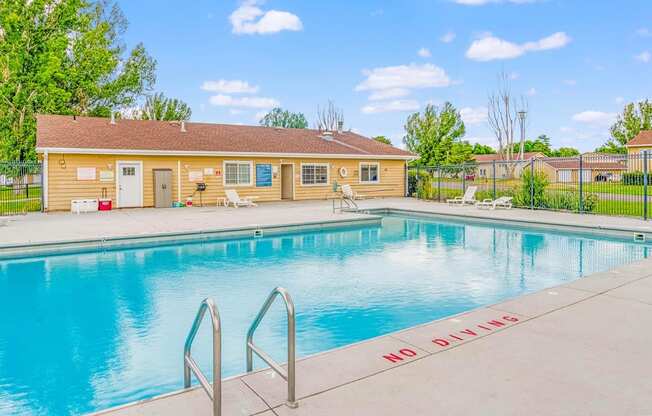 our apartments have a swimming pool with a building in the background