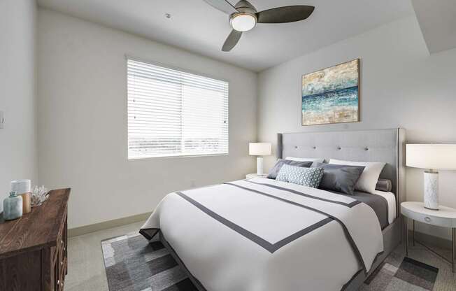 A bedroom with a large bed and a ceiling fan at Montecito at Carlsbad, Carlsbad, CA 92010