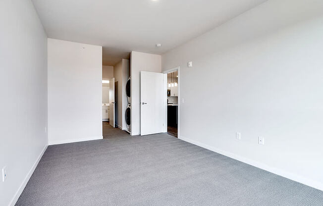 empty bedroom with gray carpet and white walls