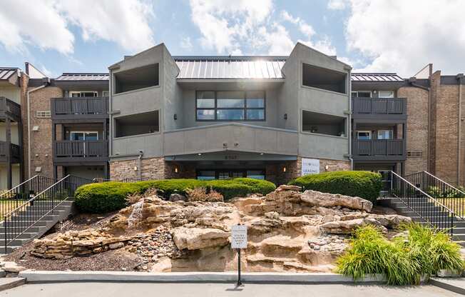 A modern building with a rocky outcrop in front.