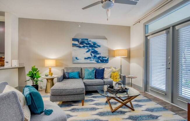 a living room with a couch and a ceiling fan at The Mark, San Antonio, TX