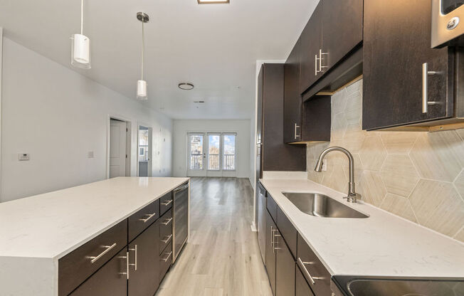 a large kitchen with a sink and counter tops