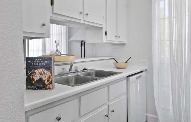 A book about cooking sits on a kitchen counter.