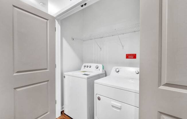 a white laundry room with a washer and dryer