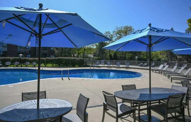 outdoor tables and lounge chairs around The Addison at Southfield swimming pool