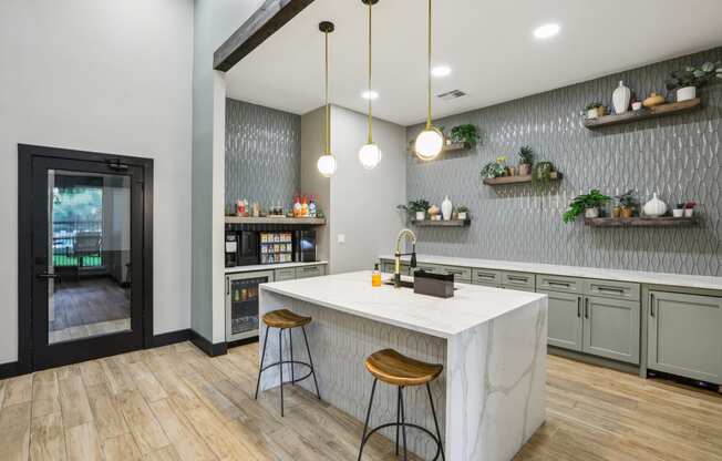 a kitchen with a marble counter top and two stools