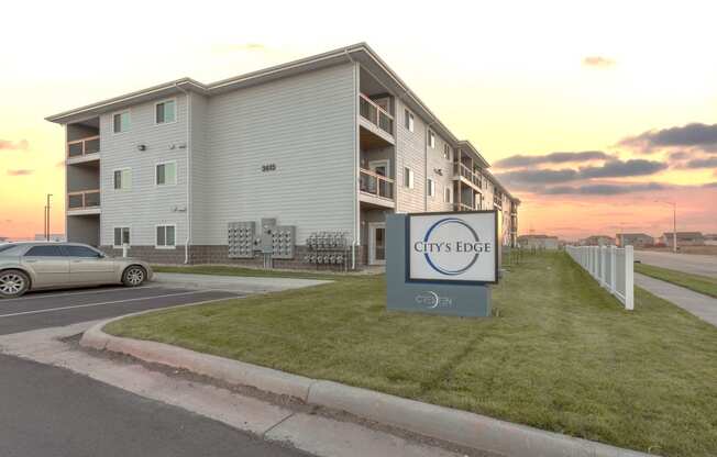 an apartment complex with a car parked in front of it