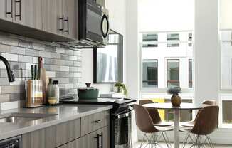 A modern kitchen with a dining table and chairs.