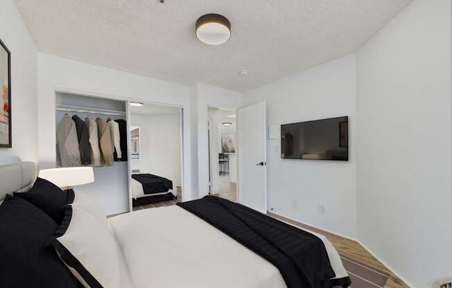 A bedroom with a bed and a wardrobe.