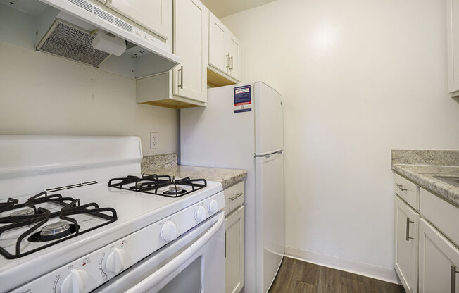 a kitchen with hard surface flooring at Newport Village Apartments, Portage, MI