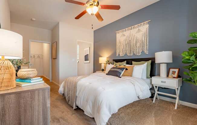 a bedroom with a large bed and a ceiling fan