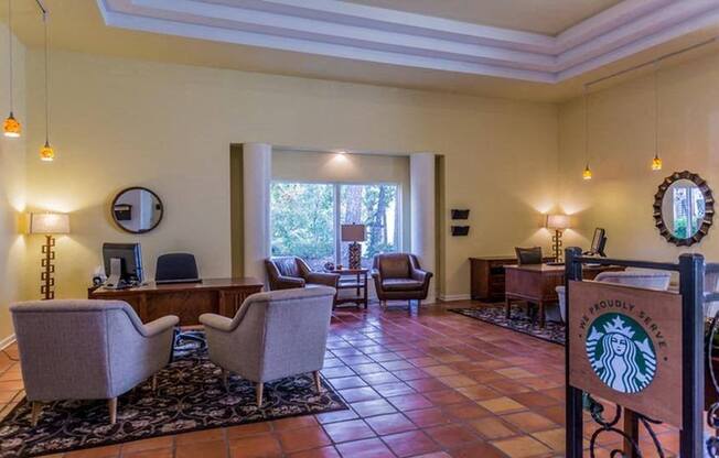 a lobby with a desk and chairs and a reception area