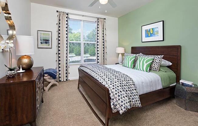 a bedroom with a bed and a ceiling fan