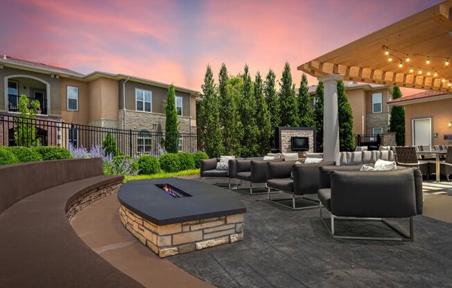 a large patio with chairs and a fire pit