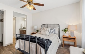Bedroom with a bed and a ceiling fan at Lofts of Wilmington, Wilmington, NC