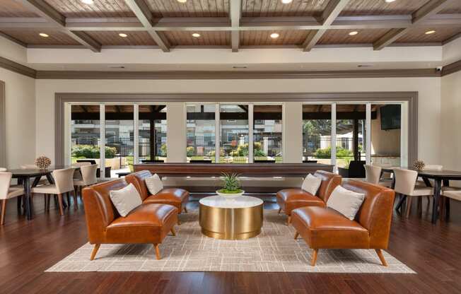 a lounge area with leather chairs and a coffee table